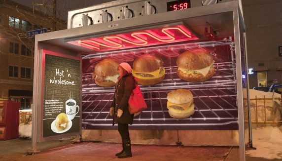 a bus stop designed to look like a gigantic oven with cheeseburgers
