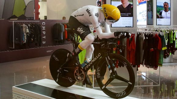 A 3D printed mannequin riding on a bike, created with additive manufacturing