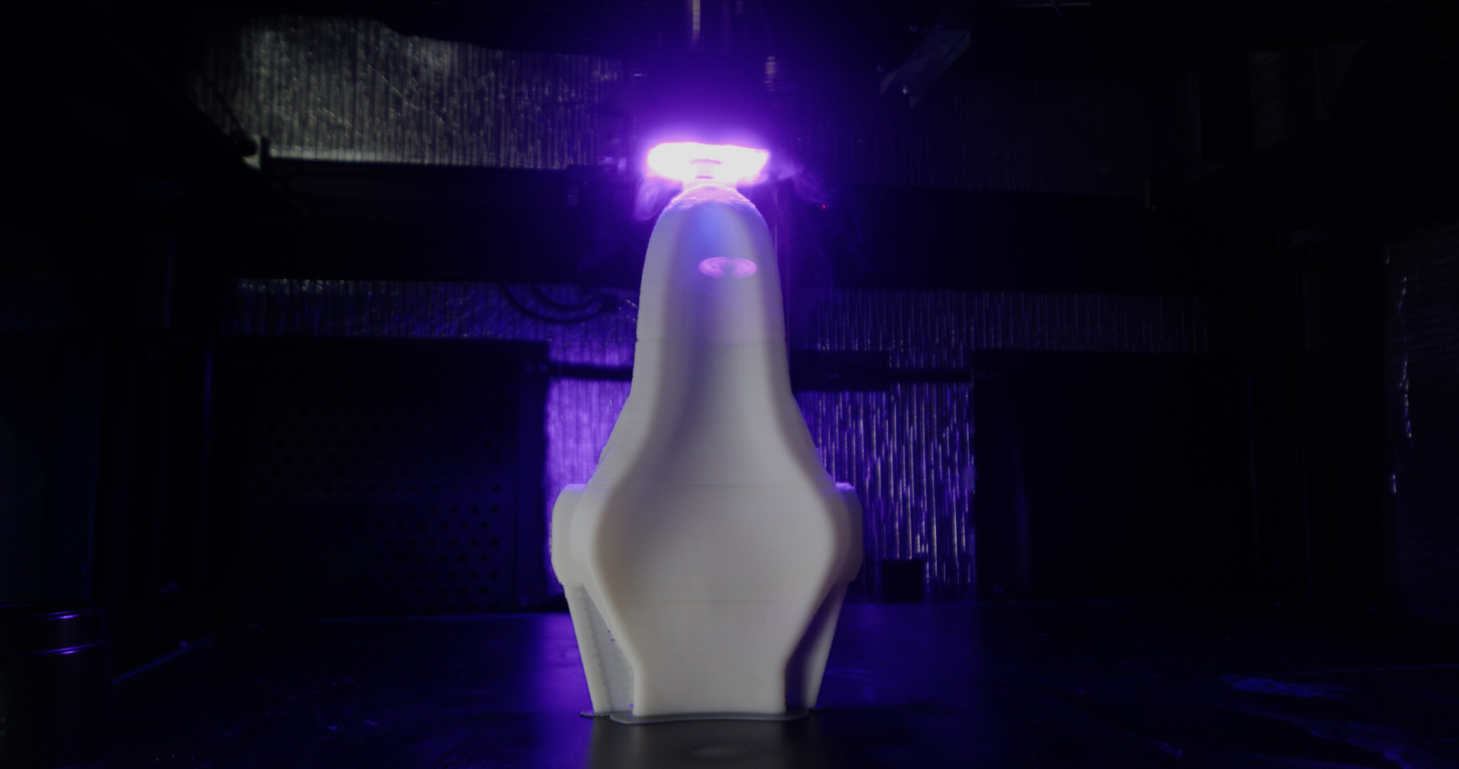 A mold created with the Massivit 10000,  seen inside the printer, beneath the UV curing light. 