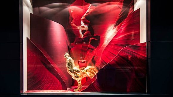 a red bag on the back of a 3D printed golden rooster