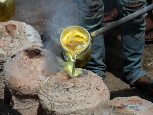 Casting metal poured into old-fashioned mold